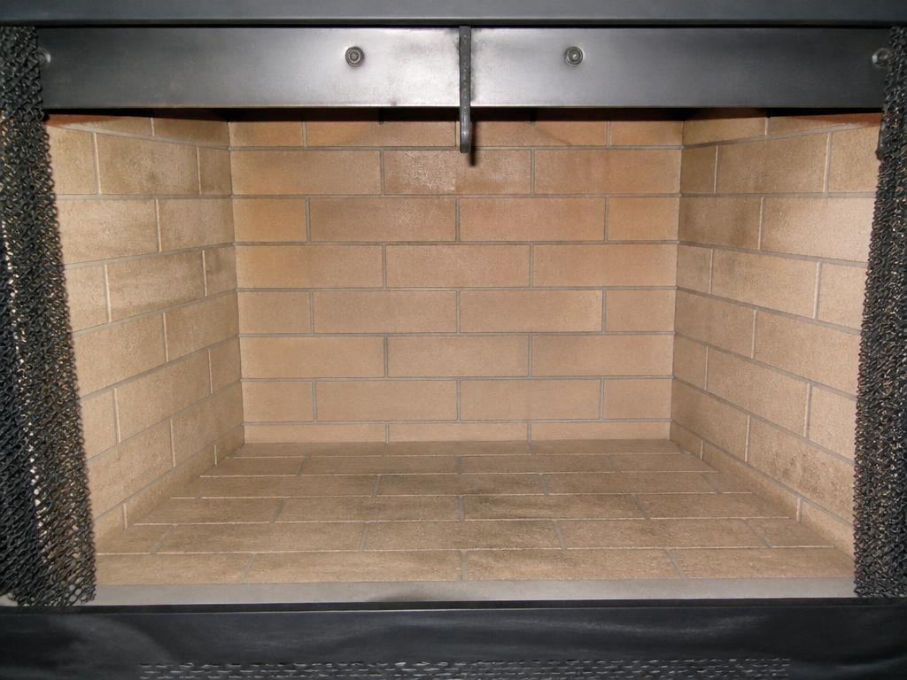 Fireplace firebox with clean brick after professional chimney sweeping